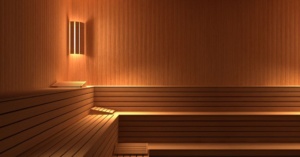 Empty wooden sauna room with tiered benches, ideal as a sauna for sore joints and relaxation.