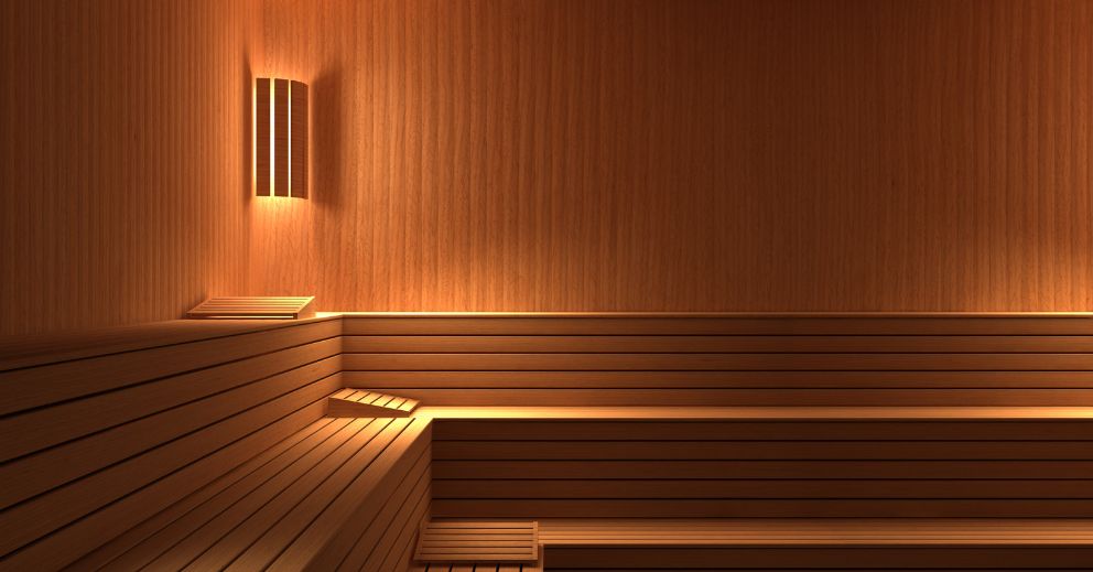 Empty wooden sauna room with tiered benches, ideal as a sauna for sore joints and relaxation.